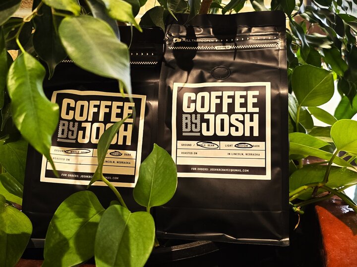 Bags of Roasted Coffee Beans Surrounded by Plants